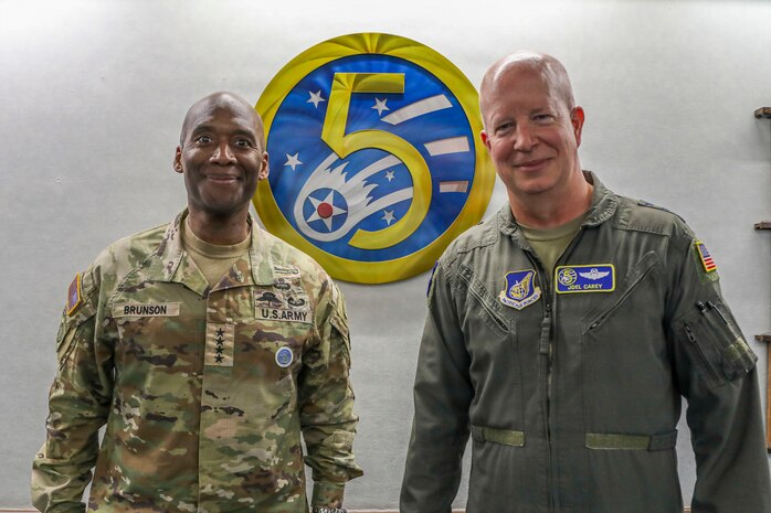 U.S. Army Gen. Xavier T. Brunson, commander of USFK, poses with Air Force Lt. Gen. Joel Carey, commander of 5th Air Force, to discuss operational planning at Yokota Air Base, Japan.