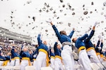 The U.S. Air Force Academy Class of 2026 graduates toss their hats skyward as the U.S. Air Force Thunderbirds fly over Falcon Stadium in Colorado Springs, Colo., May 28, 2026. A total of 931 cadets received commissions as second lieutenants in the U.S. Air Force and U.S. Space Force.  (U.S. Air Force photo/Adalyn Greene)