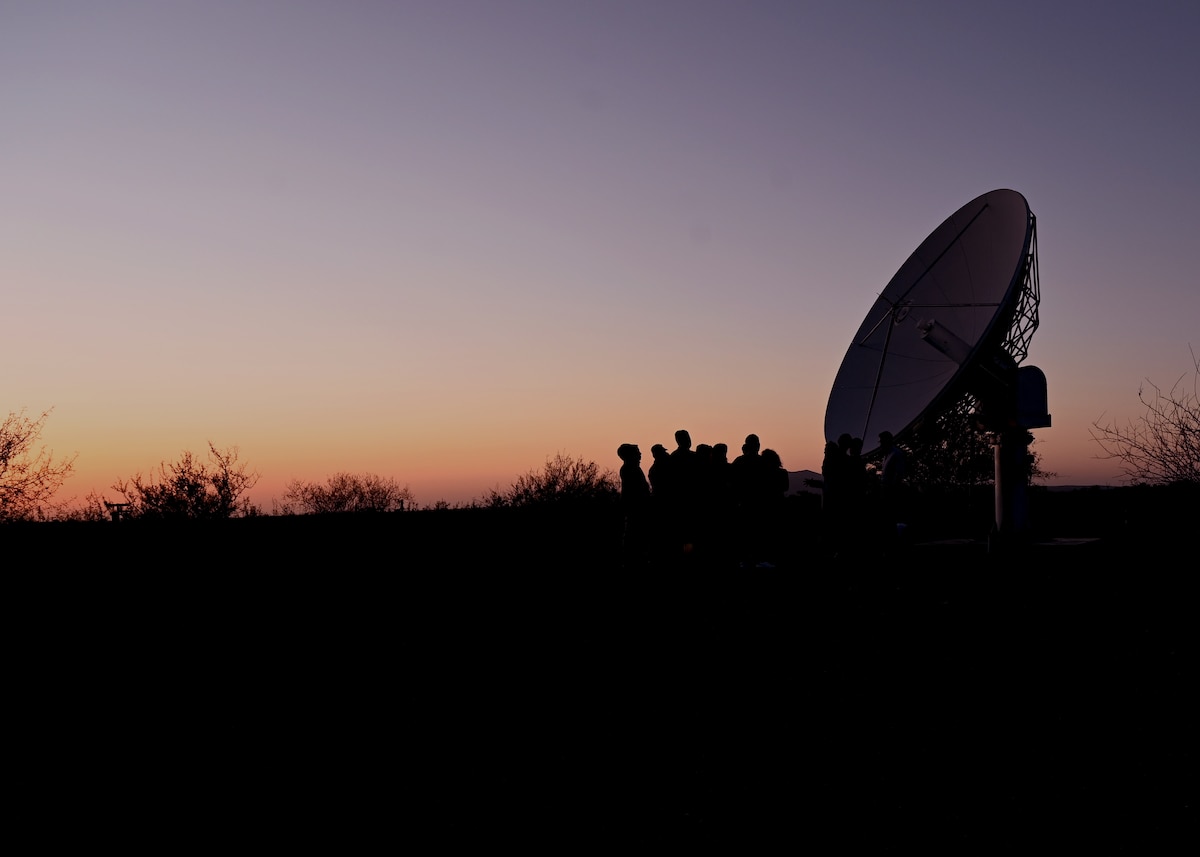 Participants in a space immersion tour observe a satellite communications dish at the University of Arizona's Space4 Center in Oracle, Arizona, May 27, 2026. The experience provided U.S. Space Force Guardians, foreign liaison officers and family members with a firsthand look at space domain awareness capabilities and the academic partnerships that support space research, education and innovation. (U.S. Air Force photo by Staff Sgt. Abbey Rieves)