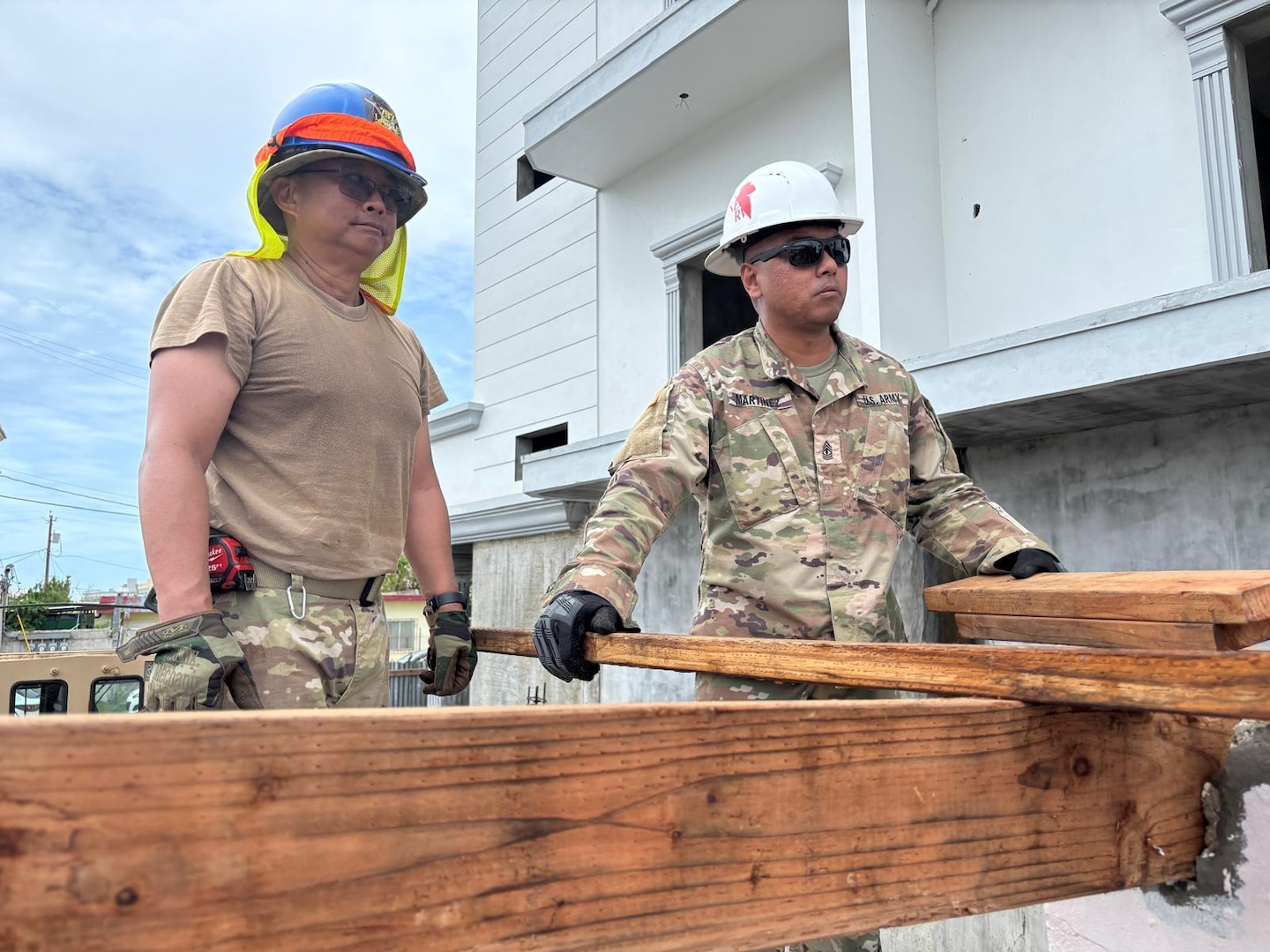 Two Army Reserve soldiers on the roof working.