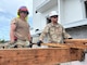 Two Army Reserve soldiers on the roof working.