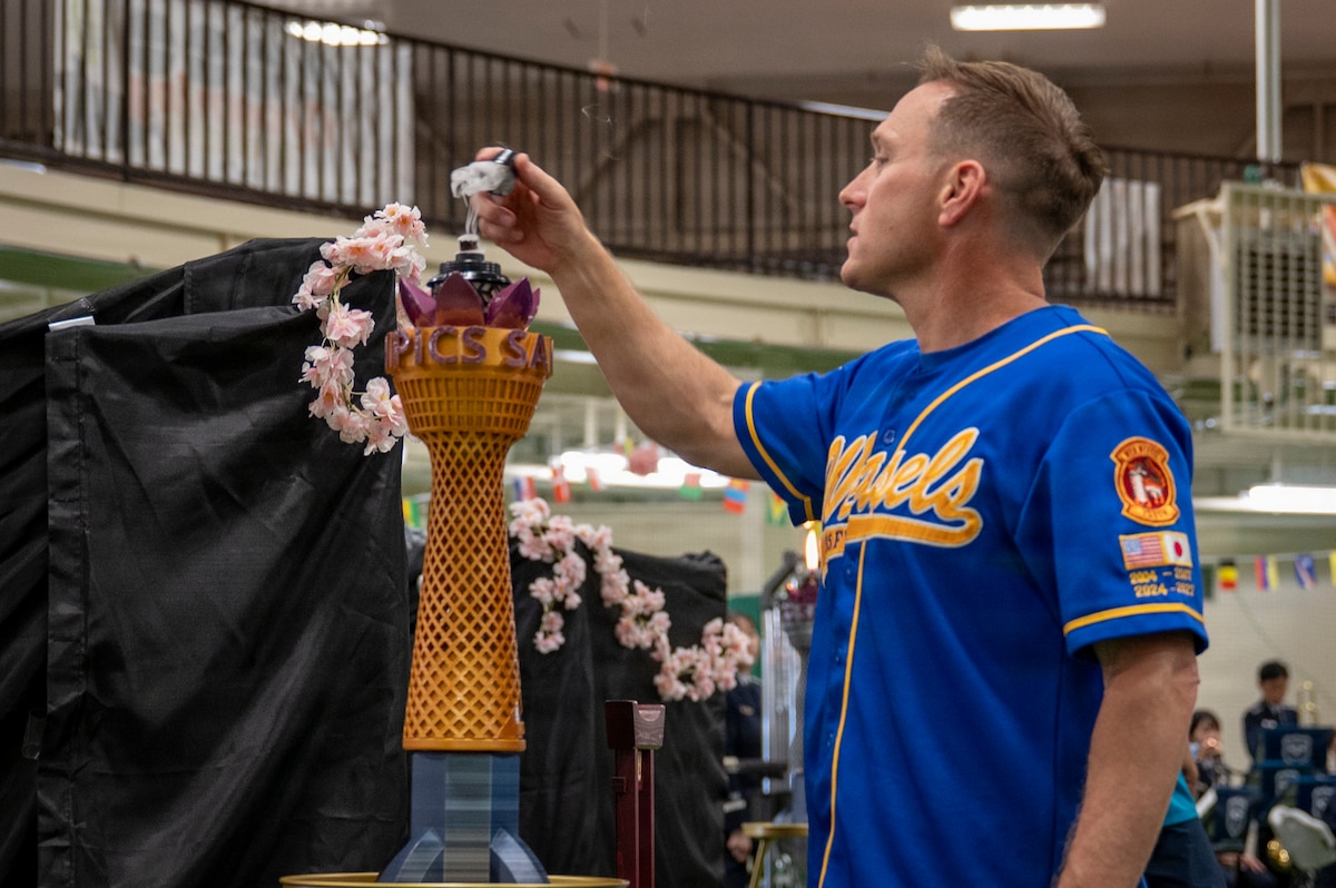 U.S. Air Force Col. Paul Davidson, 35th Fighter Wing commander, extinguishes a ceremonial flame during the Sakura Olympics 2026 closing ceremony at Misawa Air Base, Japan, May 29, 2026. The annual event encouraged teamwork, camaraderie and friendly rivalry while strengthening relationships between U.S. forces and Japan Air Self-Defense Force members. (U.S. Air Force photo by Senior Airman Brittany Russell)