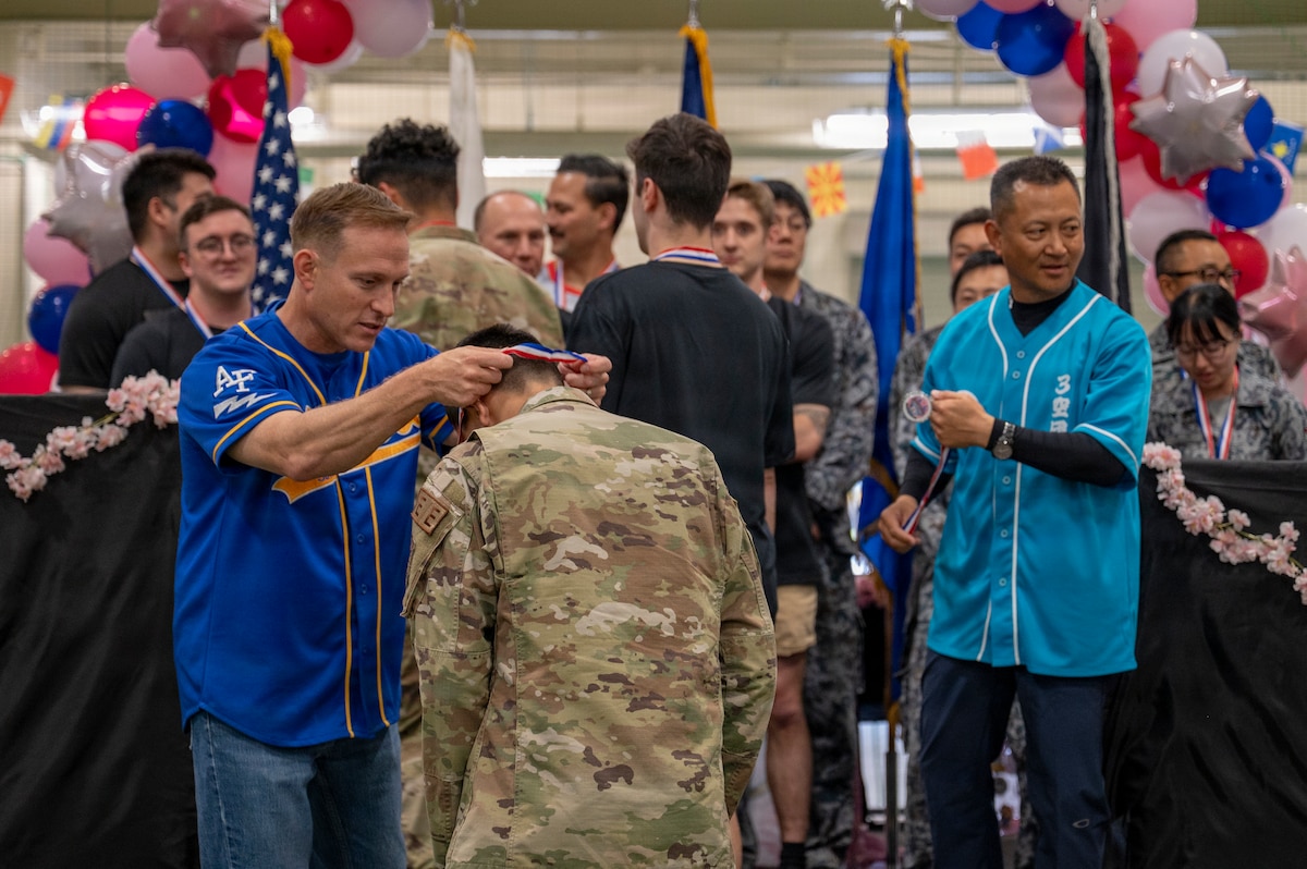 Participants receive medals on stage during the Sakura Olympics 2026 closing ceremony at Misawa Air Base, Japan, May 29, 2026. Friendly competition throughout the event promoted teamwork, sportsmanship and stronger ties within the Misawa community. (U.S. Air Force photo by Senior Airman Brittany Russell)