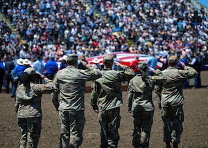 Service members salute during the National Anthem and presentation of the American flag at Military Appreciation Day during the Santa Maria Elks Rodeo in Santa Maria, Calif., May 31, 2026. The event honored military members and veterans while highlighting the longstanding partnership between Vandenberg Space Force Base and the Central Coast community. The annual Santa Maria Elks Rodeo is celebrating its 83rd year in 2026. The annual rodeo brings together competitors and spectators from across the Central Coast for a weekend of western sports and entertainment, including bull riding, horseback competitions, lasso contests, mutton busting, and more. (U.S. Space Force photo by Airman 1st Class Olya Houtsma)
