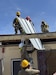 Army soldiers working on a roof.