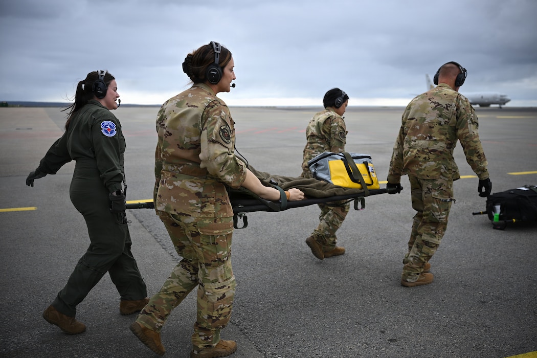 U.S. Air Force 86th Aeromedical Evacuation Squadron and 86th Medical Group critical care air transportation members offload a litter from an aircraft