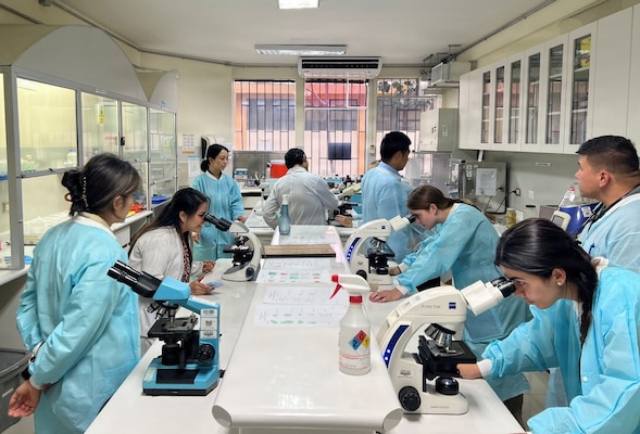LIMA, Peru (Aug. 4, 2026) Students with the Military Tropical Medicine (MTM) Field Mission perform microscopy, searching for parasitic organisms under the supervision of laboratory staff with Cayetano Heredia. The MTM program advances strategic objectives by training and equipping military medical providers to deliver high-quality care in austere environments. NAMRU SOUTH, part of Navy Medicine Research & Development, conducts research, surveillance and studies of vaccines, therapeutic agents, diagnostic assays and vector control measures in the SOUTHCOM Area of Responsibility to better prevent and treat infectious diseases in support of Navy, Marine Corps and joint U.S. warfighter health, readiness and lethality. Navy Medicine’s 44,000+ talented and ready forces optimize health readiness, deliver quality healthcare, and provide global expeditionary medical support to warfighters. (U.S. Navy Photo by Lt. Cmdr. Jeffrey Spiro/ Released)