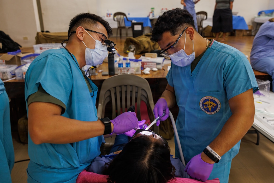 260804-M-HP122-1013 U.S. Navy Lt. Alex Pham, a general dentist, left, and Petty Officer 3rd Class Matthew Segovia, a dental corpsman, both assigned to 1st Dental Battalion, 1st Marine Logistics Group, conduct oral surgery on a local during Exercise Koa Moana 2026 in Koror, Palau, Aug. 4, 2026. Koa Moana 26 is an annual partnership in Indo-Pacific region that strengthens established relationships, bolsters theater security cooperation, and enhances the resilience of our allies and partners through community outreach, medical and civic assistance, infrastructure improvement projects, and key leader exchanges. During Koa Moana, Sailors provided critical dental care, contributing to sustainable development and regional prosperity. (U.S. Marine Corps photo by Sgt. Mary Torres)