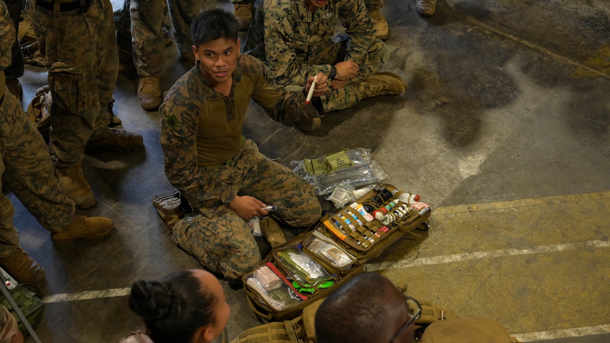 260818-M-YV233-1753 U.S. Navy Petty Officer 3rd Class Richard Thalla, a corpsman with 1st Battalion, 5th Marine Regiment, Marine Rotational Force – Darwin 26, explains the contents of his medical pack for a Tactical Combat Casualty Care exchange during Exercise DELAYEN 26 in Tahiti, French Polynesia, Aug. 19, 2026. Exercise DELAYEN 26 is a bilateral training exercise between Marine Rotational Force – Darwin 26 and the French Armed Forces in French Polynesia designed to enhance tactical interoperability among forces in the Indo-Pacific. Thalla is a native of California. (U.S. Marine Corps photo by Cpl. Nan Yang)