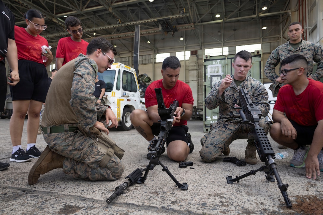 U.S. Marines with Littoral Combat Force-24 show Marine Corps prospects, or poolees, how to disassemble a M240B medium machine gun during a static display at Jose Aponte De La Torre Airport in Ceiba, Puerto Rico, Aug. 29, 2026. The event provided future Marines with firsthand mentorship, physical training, and an up-close look at the gear and operational capabilities they will utilize in the Fleet Marine Force. (U.S. Marine Corps photo)