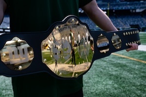 The 2026 Salute to Service Bowl championship belt is held on display before the flag football game at MetLife Stadium, N.J., Aug. 28, 2026. Service members assigned to Joint Base McGuire-Dix-Lakehurst and Fort Hamilton, N.Y., participated in the annual flag football game to see who would claim the coveted champion belt. (U.S. Air Force photo by Airman 1st Class Haeleigh Bayle)