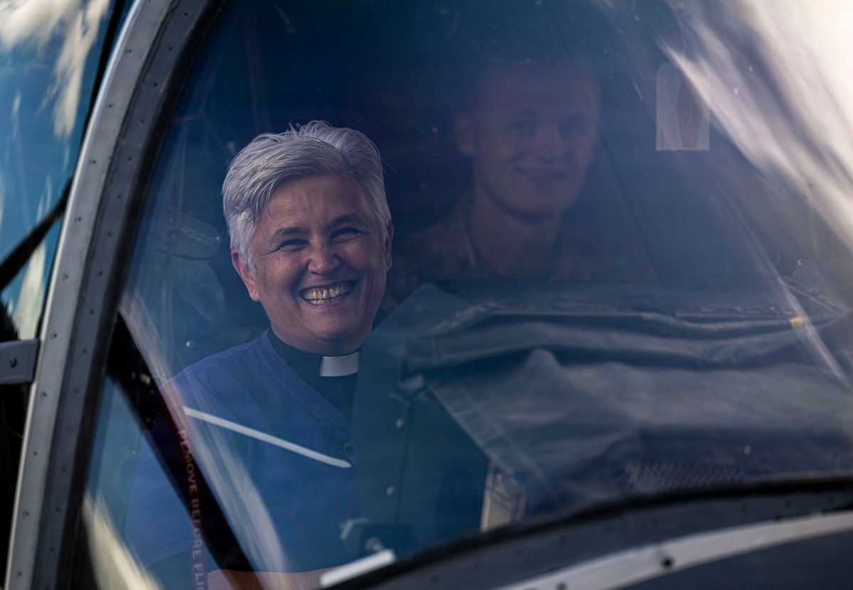 Diane Grano, reverend at St. Christopher's Church, smiles while sitting in a CV-22 Osprey during Clergy Day at RAF Mildenhall, England, Aug. 20, 2026.