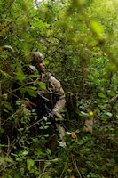 A U.S. Army Soldier assigned to the 173rd Mobile Brigade Combat Team, takes cover during a simulated drone attack during exercise Saber Junction 26 at the Hohenfels Training Area in the Joint Multinational Readiness Center, Germany, Aug. 28, 2026. The 7th Army Training Command provides a unique environment in Europe to develop leaders and formations who are prepared for large-scale combat operations, improving readiness. (U.S. Army photo by Spc. Kaleb Lampkin)
