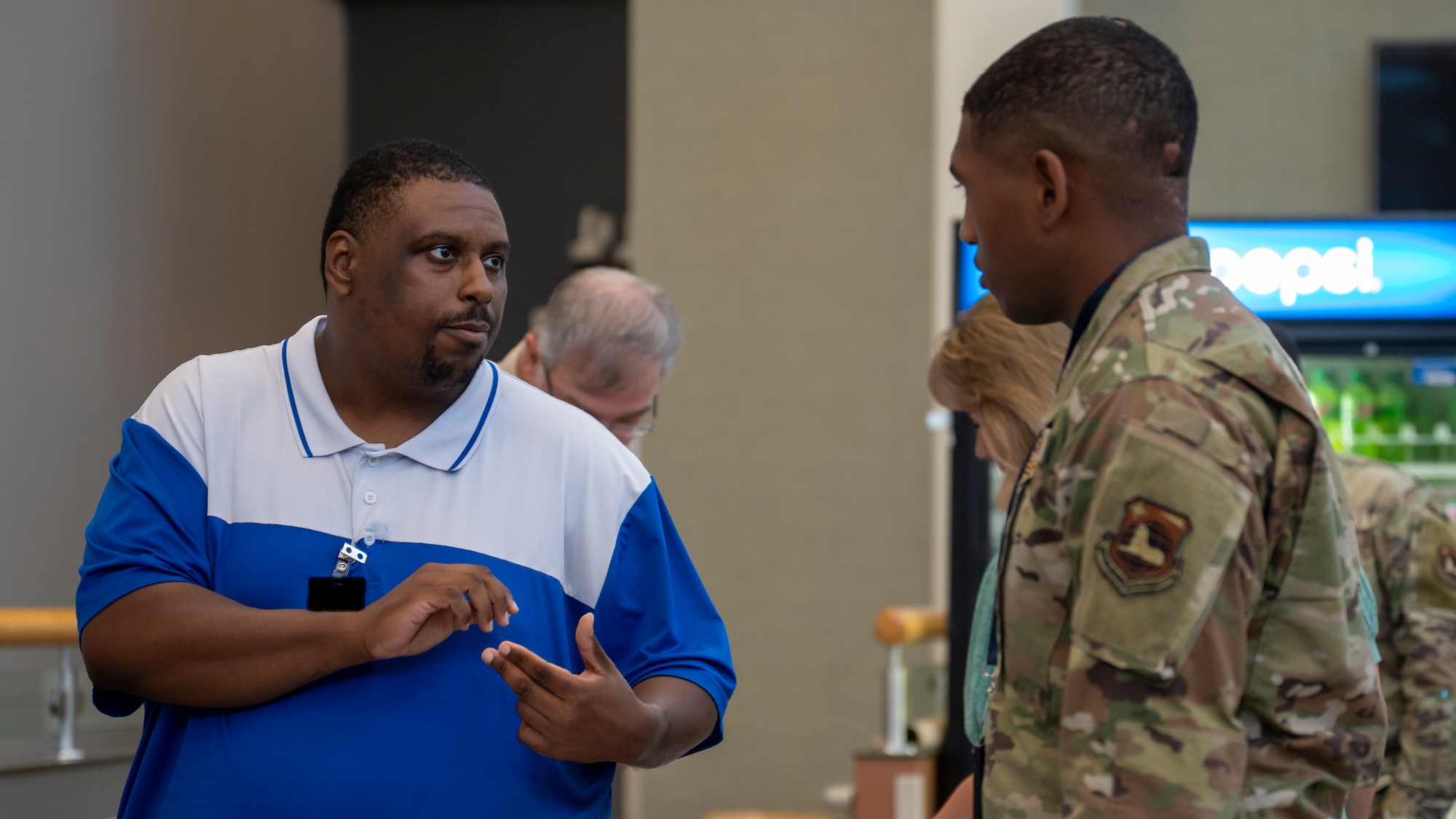 Brandon Harvey, left, speaks with Senior Airman Orenthal Womack about education opportunities.