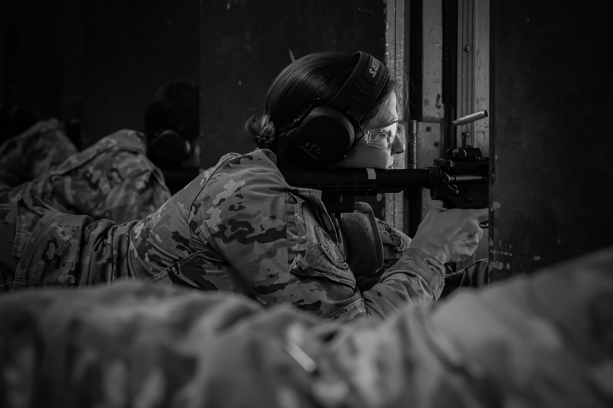 A U.S. Air Force service member fires an M4 carbine.
