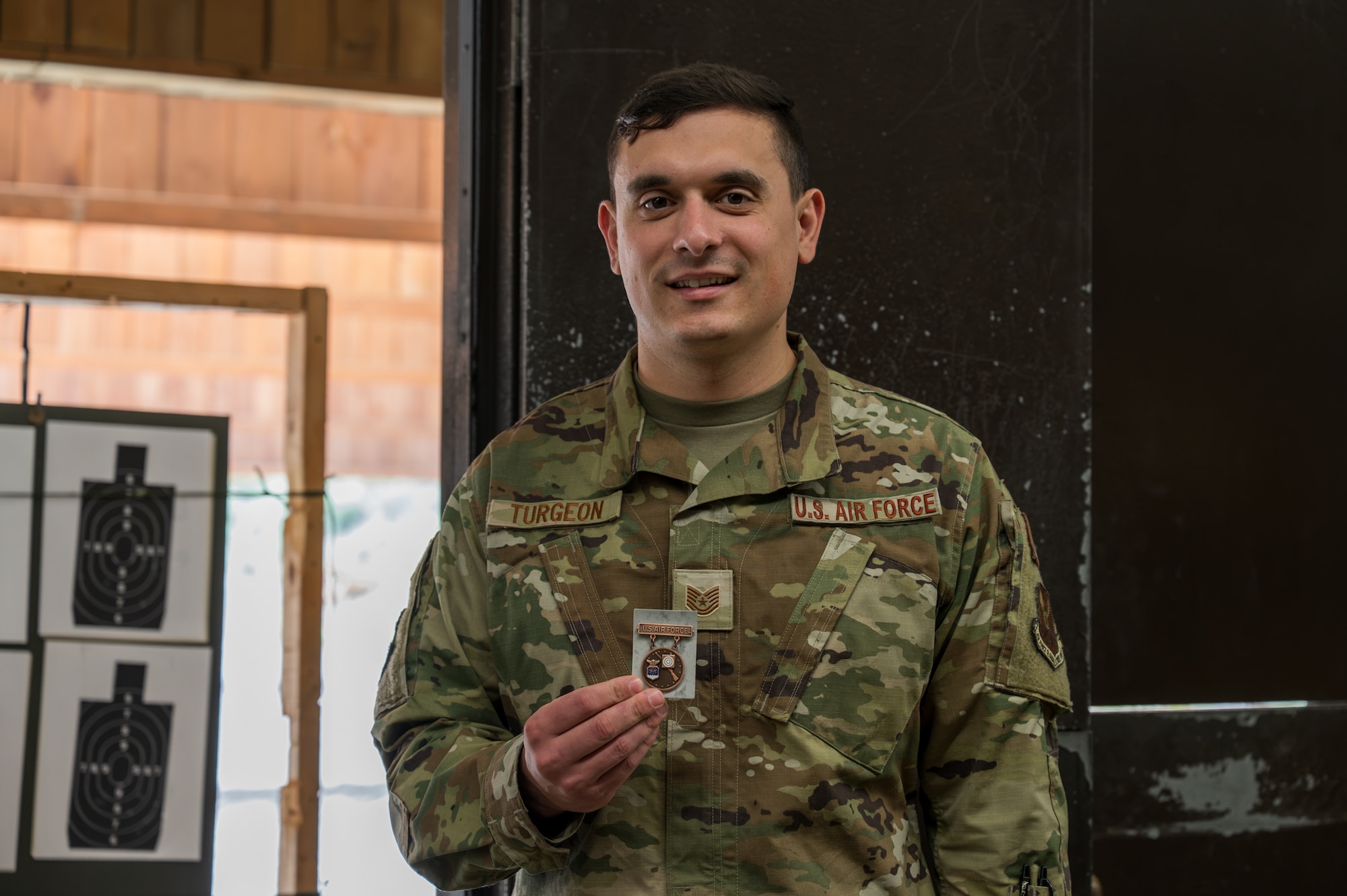 U.S. Air Force service member holds the U.S. Air Force Excellence-in-Competition Rifleman Badge.