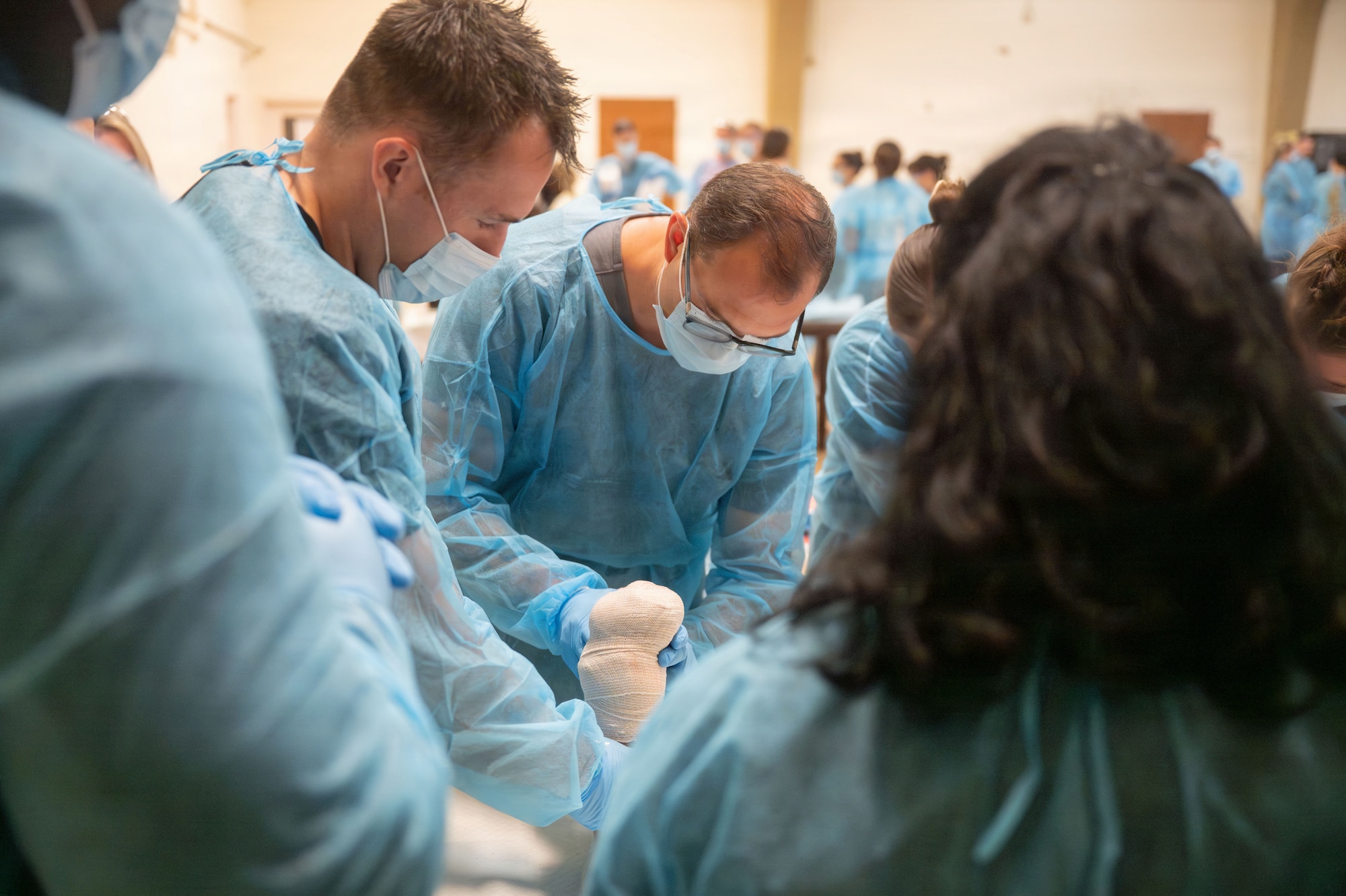 U.S. Airmen, assigned to the 124th Medical Group, practice wound care techniques during an advanced medical training cadaver lab at Marine Corps Base Hawaii, Aug. 25, 2026.