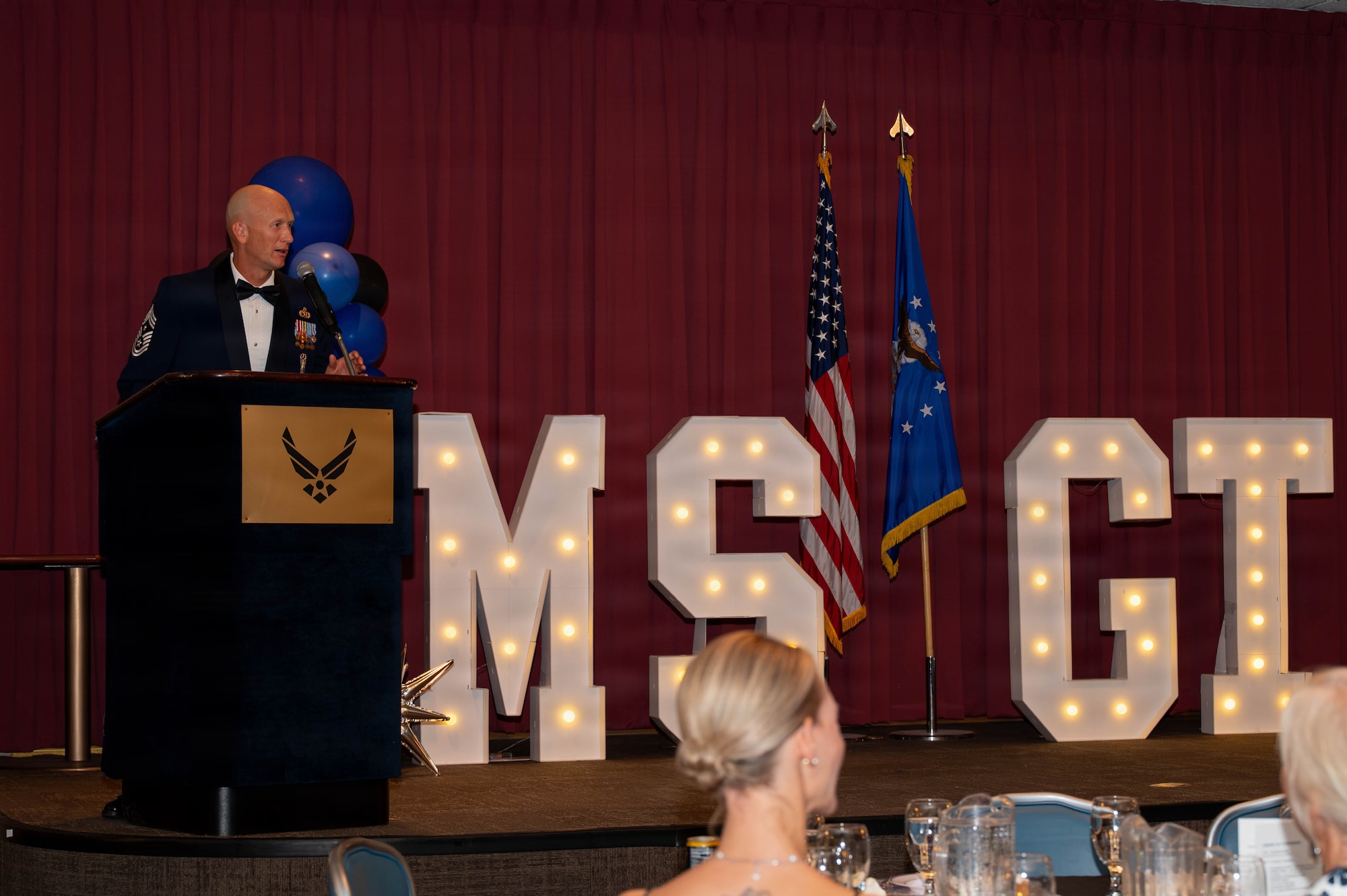 man speaks to attendees of ceremony