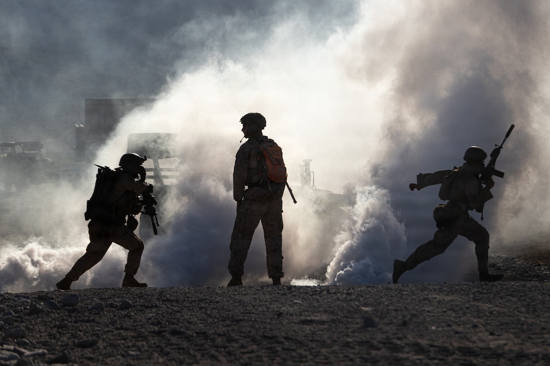 U.S. Marines with Echo Company, 2nd Battalion, 1st Marine Regiment, 1st Marine Division, maneuver to a building during a platoon-level urban assault as part of Service Level Training 4-26 at Marine Corps Air-Ground Combat Center Twentynine Palms, California, Aug. 30, 2026. SLTE is designed to be a challenging, realistic training exercise that produces combat-ready forces capable of operating as an integrated Marine Air-Ground Task Force across all domains of military operations. (U.S. Marine Corps photo by Lance Cpl. Journey Fisher)