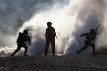 U.S. Marines with Echo Company, 2nd Battalion, 1st Marine Regiment, 1st Marine Division, maneuver to a building during a platoon-level urban assault as part of Service Level Training 4-26 at Marine Corps Air-Ground Combat Center Twentynine Palms, California, Aug. 30, 2026. SLTE is designed to be a challenging, realistic training exercise that produces combat-ready forces capable of operating as an integrated Marine Air-Ground Task Force across all domains of military operations. (U.S. Marine Corps photo by Lance Cpl. Journey Fisher)