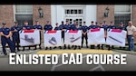 Coast Guard enlisted members who attended the Computer Aided Drawing (CAD) course hold up schematics and models of parts they designed at the Coast Guard Academy, in New London, Conn., July 2026.