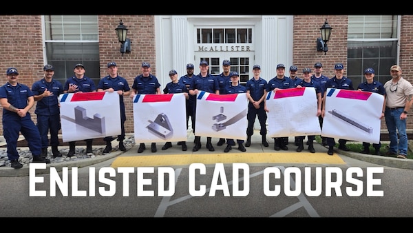 Coast Guard enlisted members who attended the Computer Aided Drawing (CAD) course hold up schematics and models of parts they designed at the Coast Guard Academy, in New London, Conn., July 2026.