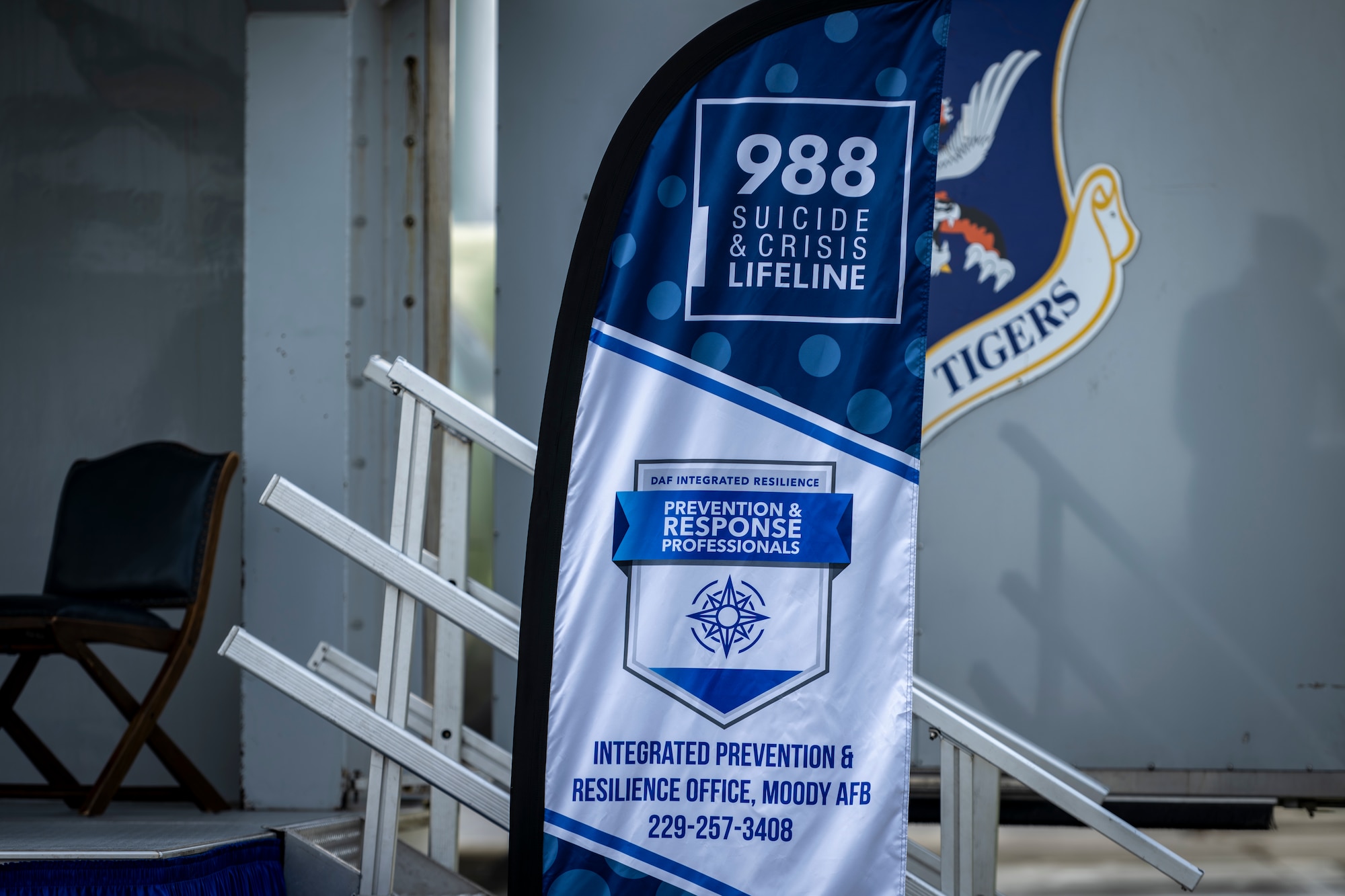 A 988 Suicide & Crisis Lifeline banner is displayed during a ceremony