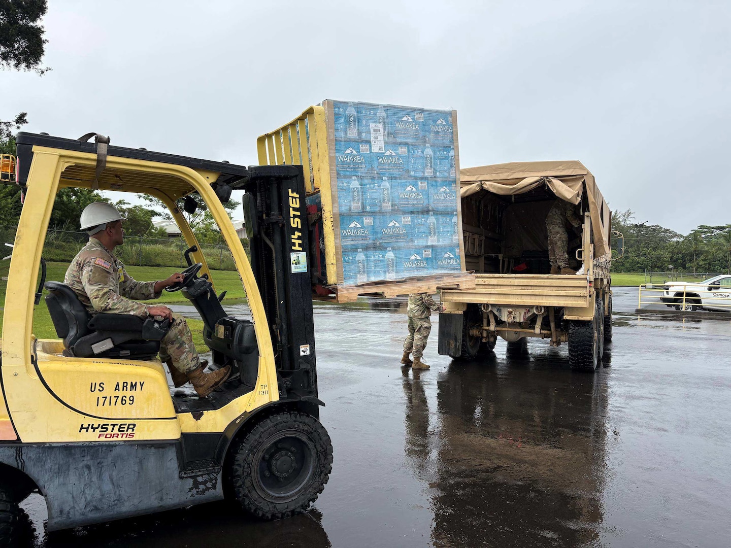 Sgt. First Class Keith Reiswig, readiness noncommissioned officer, Company B, 227th Brigade Engineer Battalion, Hawaii National Guard, assists with loading water.
