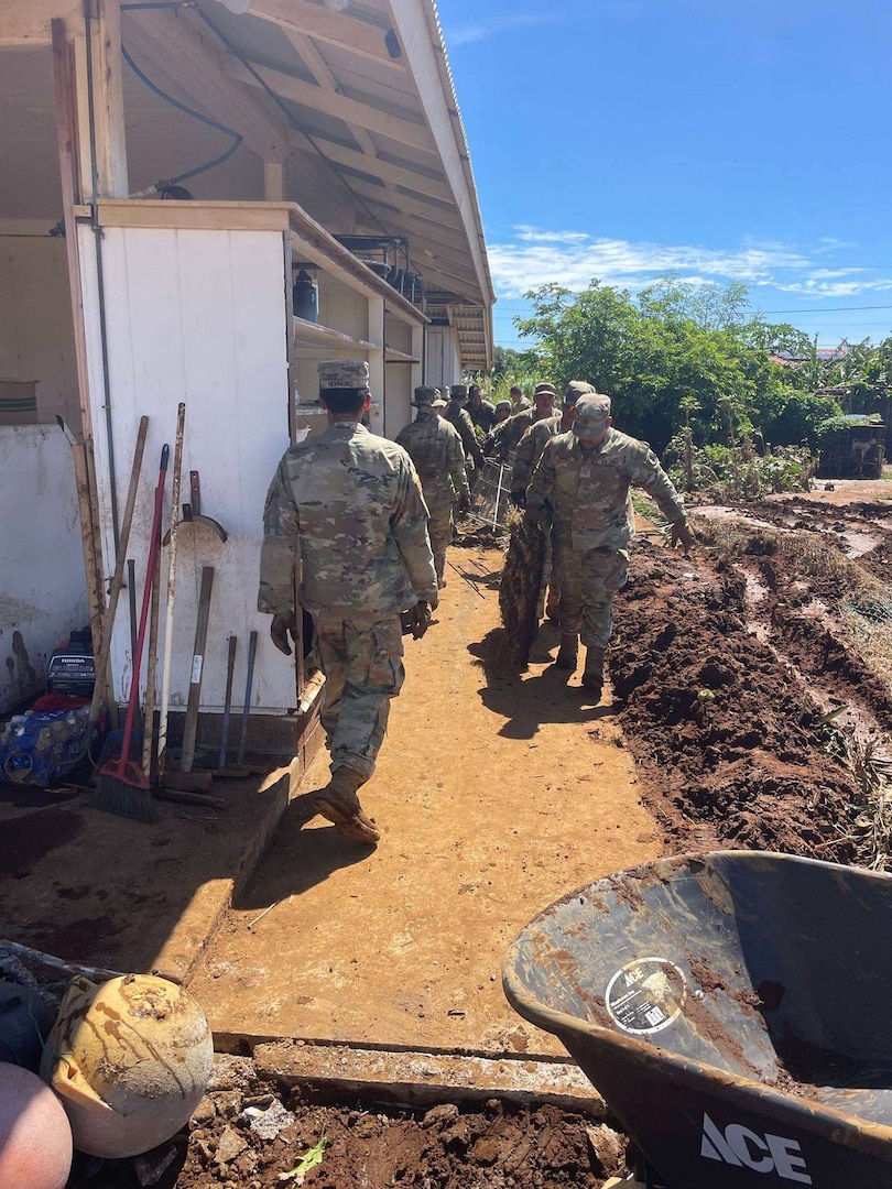 Task Force Hawaii Soldiers work in Naalehu to clear debris left behind by Tropical Storm Lala.