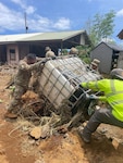 Hawaii National Guard members removing downed trees, rocks and debris from homes, helping make them safe and accessible again. Photo by Warrant Officer 1 Lokits.