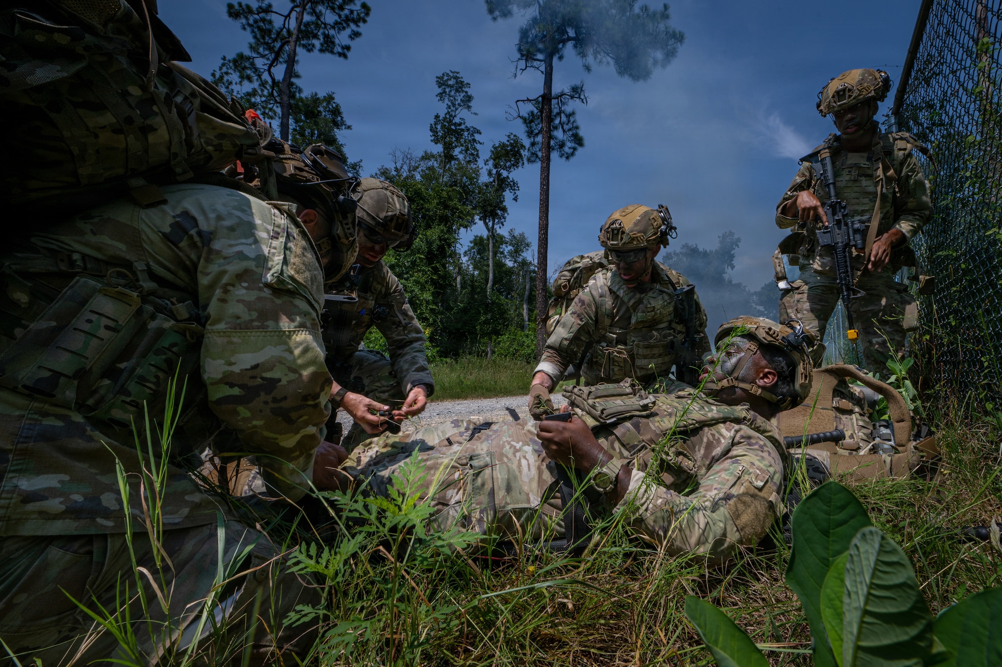 Airman getting put on a litter.