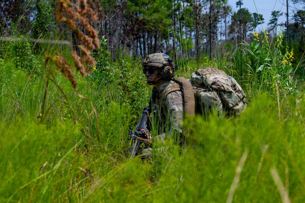 Airman kneeling.