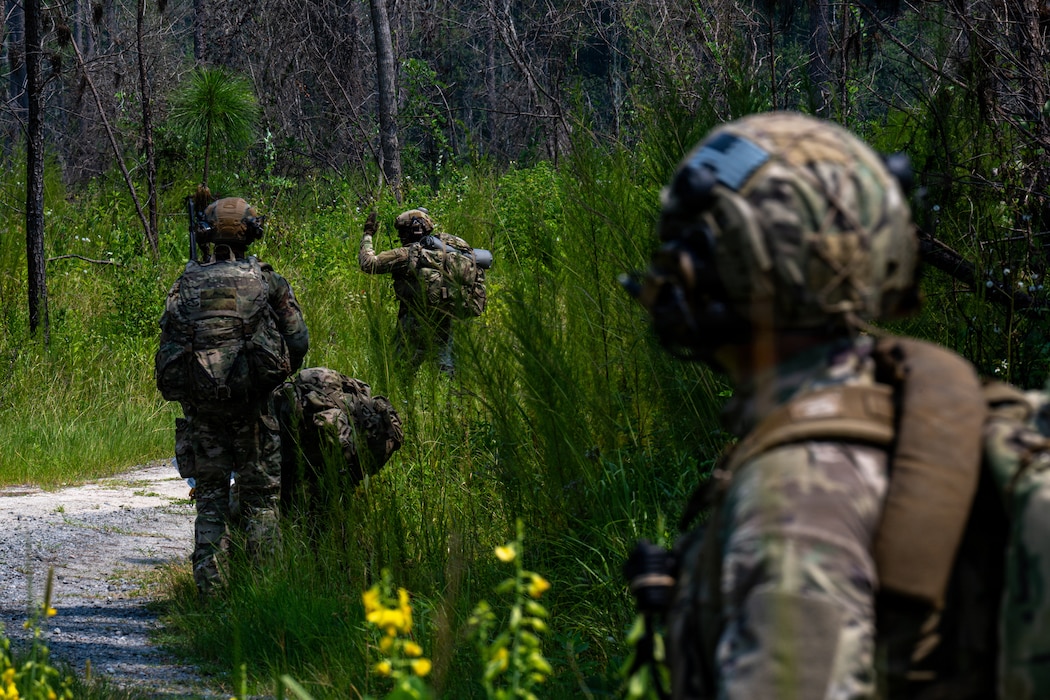 Airman motioning to follow.