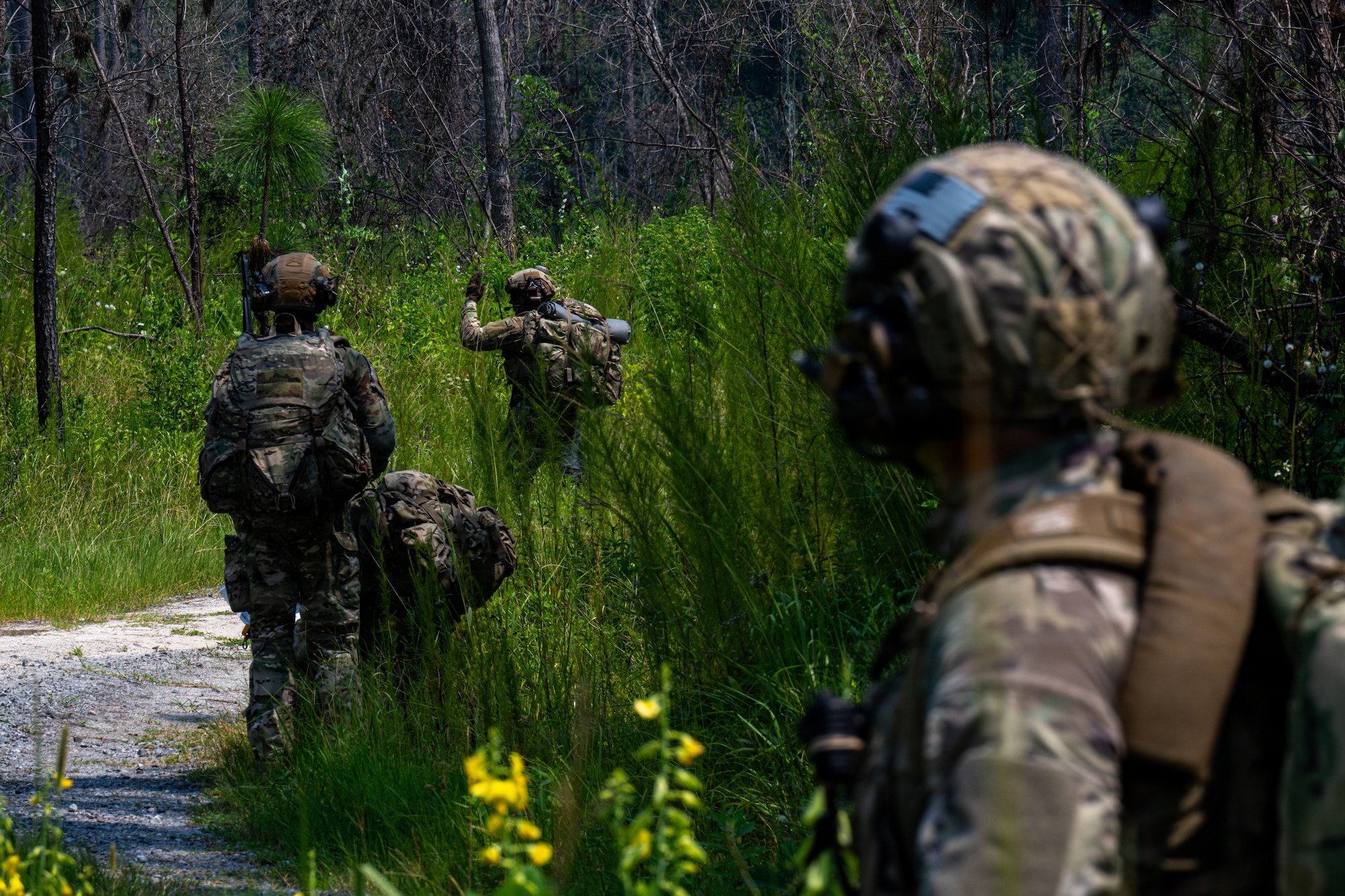 Airman motioning to follow.