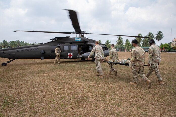 U.S. Soldiers assigned to the 11th Airborne Division take a mock casualty onto a U.S. Army UH-60 Black Hawk during cold and hot load medical evacuation training as part of Super Garuda Shield 26 at Baturaja Combat Training Center, Indonesia, Aug. 31, 2026.