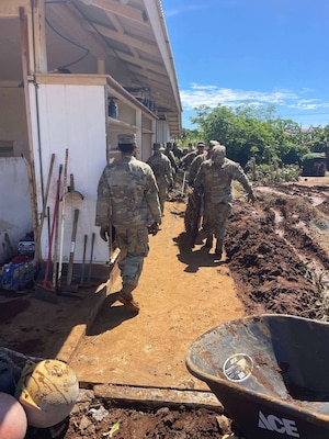 Task Force Hawaii Soldiers work in Naalehu to clear debris left behind by Tropical Storm Lala.
