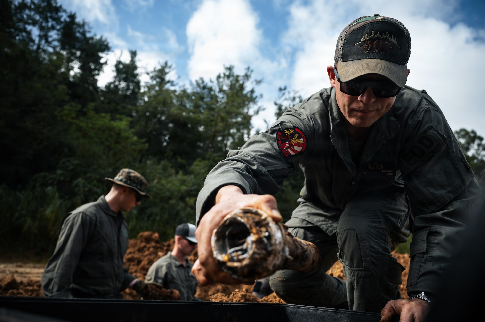 A technician grabs an exploded ordnance during exercise Sentinel Samurai.
