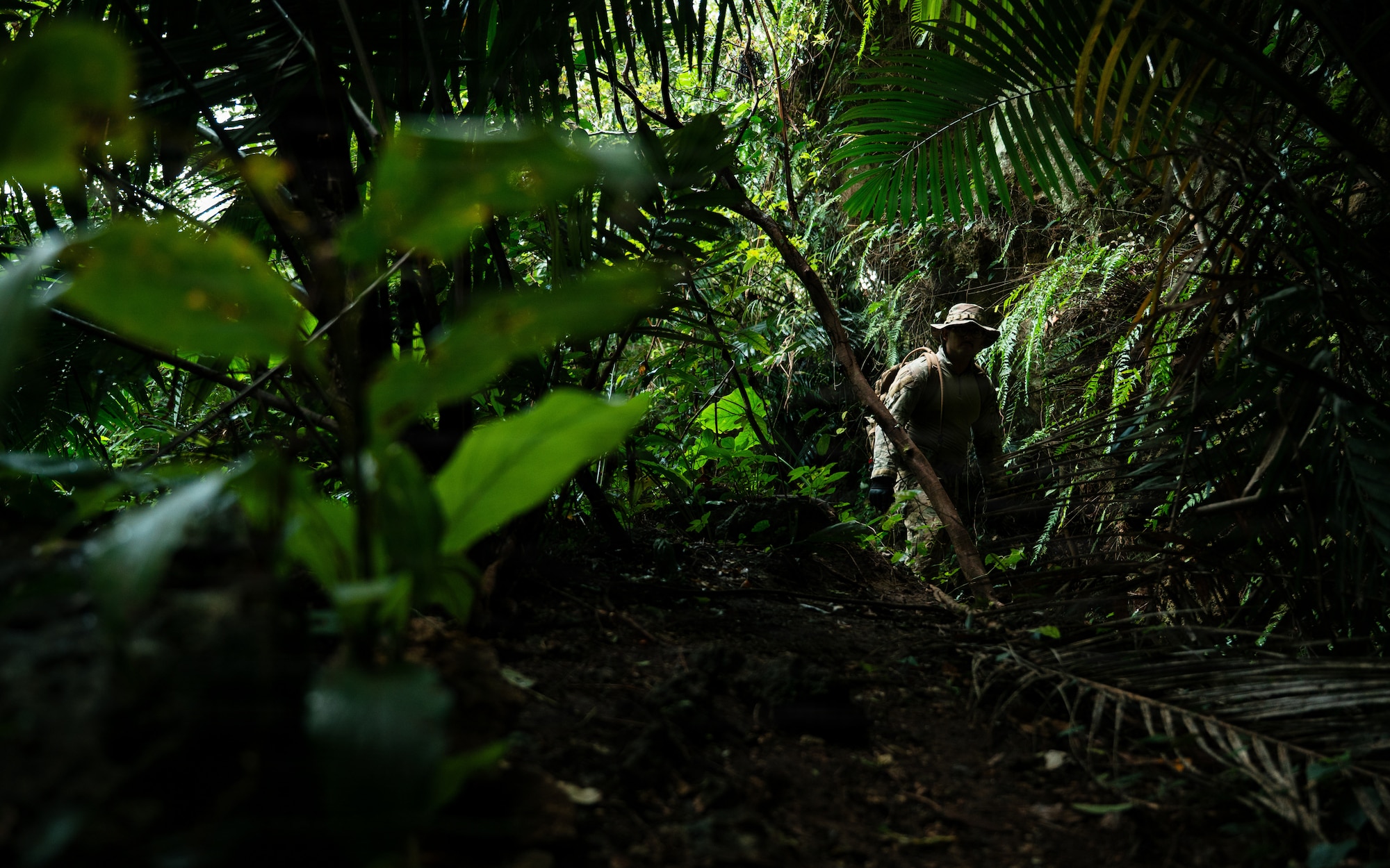 A technician searches for simulated unexploded ordnance.