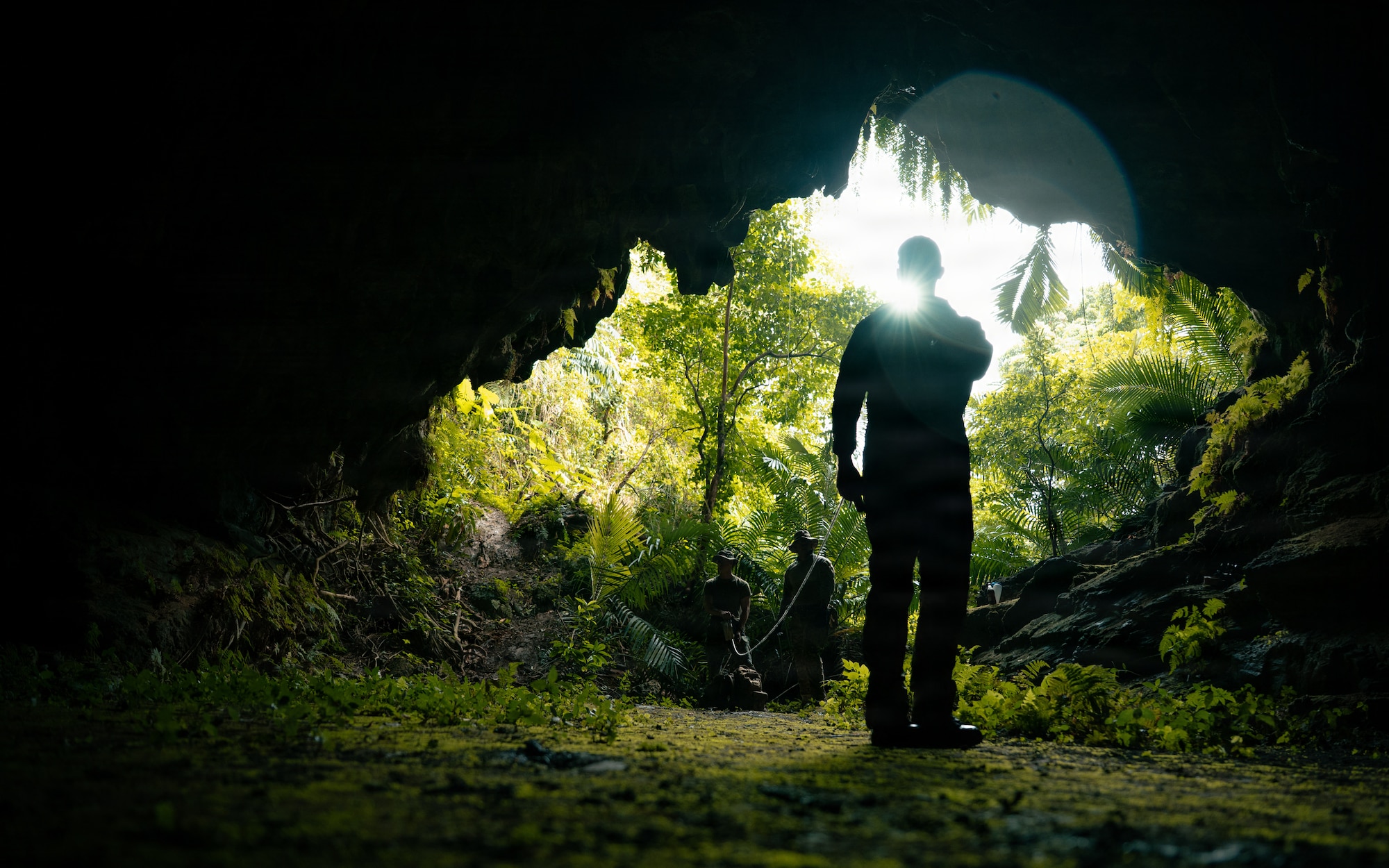 A technician search a cave for simulated unexploded ordnance during exercise Sentinel Samurai.