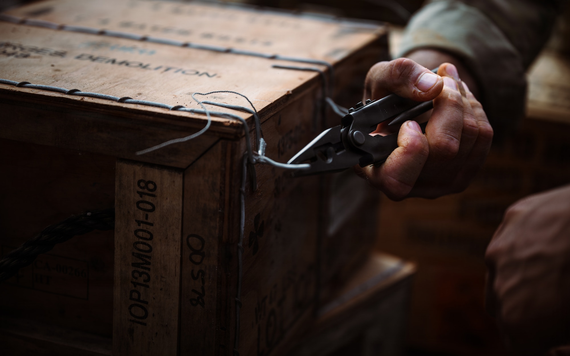 A technician opens a box of C-4 during exercise Sentinel Samurai.
