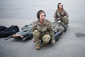 U.S. Air Force Senior Airman Rogan Jones, 86th Aeromedical Evacuation Squadron aeromedical evacuation technician, left, and U.S. Air Force Tech. Sgt. Diandra Velasquez, 86th Aeromedical Evacuation Squadron aeromedical evacuation technician, prepare to carry a litter onto an aircraft