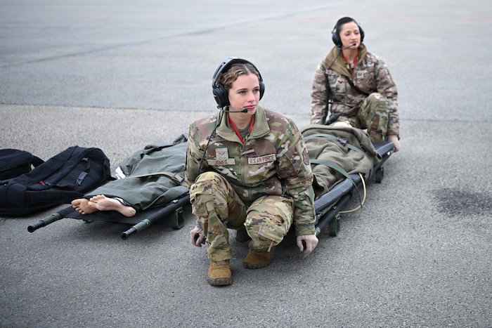 U.S. Air Force Senior Airman Rogan Jones, 86th Aeromedical Evacuation Squadron aeromedical evacuation technician, left, and U.S. Air Force Tech. Sgt. Diandra Velasquez, 86th Aeromedical Evacuation Squadron aeromedical evacuation technician, prepare to carry a litter onto an aircraft