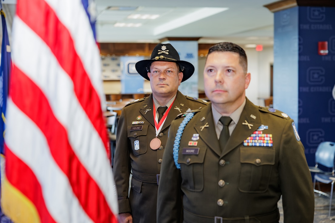 retirement ceremony standing in front of flag