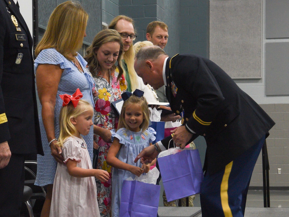 retirement ceremony retiree giving gifts to family