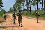 Soldiers in the field participating in a training exercise.