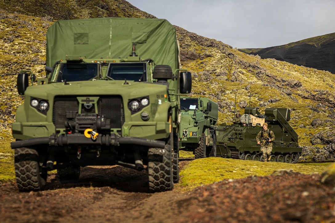 U.S. Marine Corps Joint Light Tactical Vehicles, a Strikemaster mobile anti-ship missile system, and a Norwegian Army National Manoeuvre Air Defence System displace across austere terrain while under tactical escort by Norwegian Home Guard soldiers with 3rd Platoon, District 11, in Jan Mayen, Norway, Aug. 30, 2026. The displacement and interoperability assessment, conducted during Operation Atlantic City 26, evaluated combined command, control, and multi-domain connectivity to ensure NATO can rapidly coordinate layered fires and air defense across contested environments in the High North. Atlantic City 26 is a Norwegian-led trilateral readiness initiative with the United Kingdom and United States designed to develop and demonstrate expeditionary advanced base capabilities and validate combined fires, maritime domain awareness, and sea denial to reinforce the security and stability of the High North. Jan Mayen is sovereign Norwegian territory in an isolated part of the Norwegian Sea, approximately 1,000 kilometers (620 miles) from mainland Norway. At the same time, the island occupies an important geostrategic position north of the Greenland-Iceland-U.K. gap, an area of water strategically significant to the defense of the U.S. homeland and northern Europe. (U.S. Marine Corps photo by Sgt. Noah Masog)