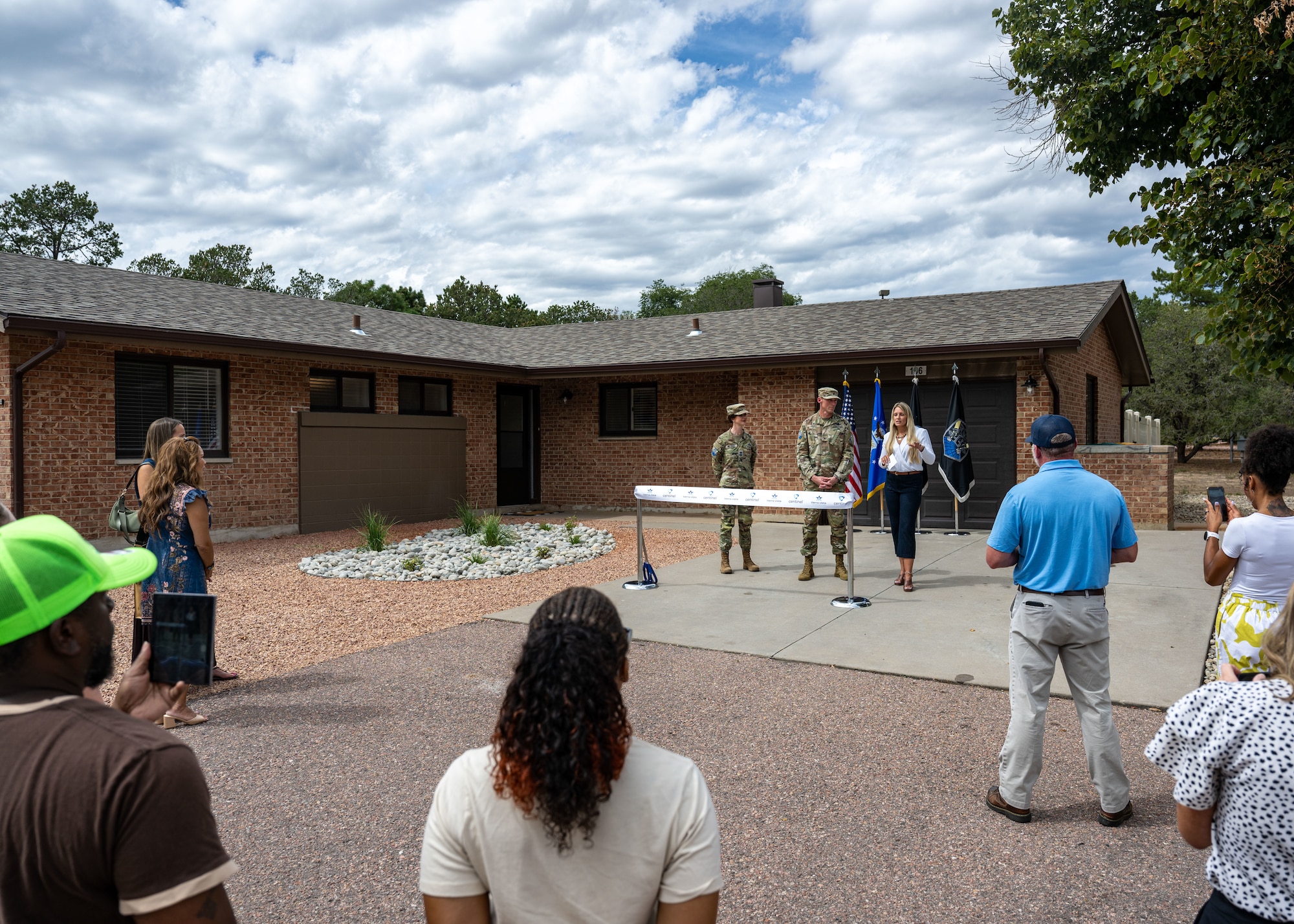 Space Base Delta 1 leadership and representatives from Tierra Vista Communities gather at a newly renovated home for junior enlisted service members.