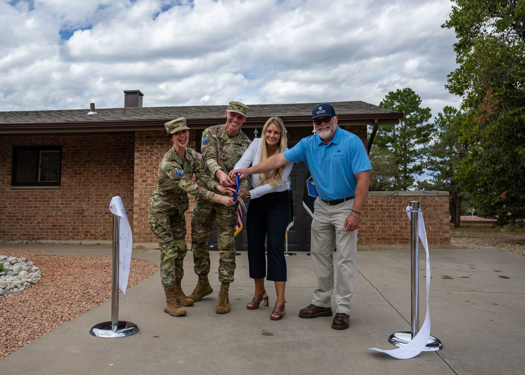 Space Base Delta 1 leadership and representatives from Tierra Vista Communities gather at a newly renovated home for junior enlisted service members.