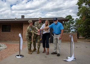 Space Base Delta 1 leadership and representatives from Tierra Vista Communities gather at a newly renovated home for junior enlisted service members.