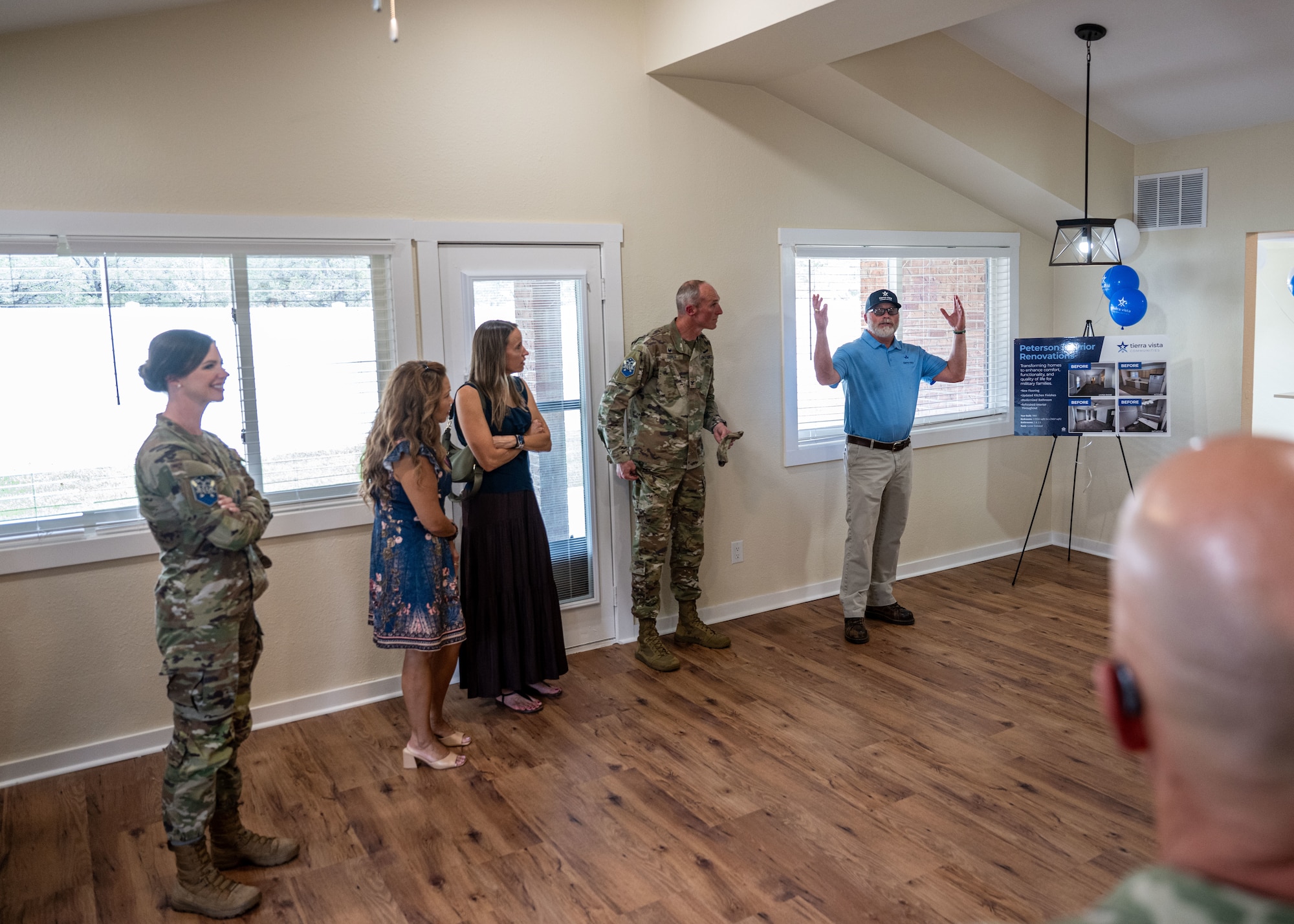 Space Base Delta 1 leadership and representatives from Tierra Vista Communities gather at a newly renovated home for junior enlisted service members.